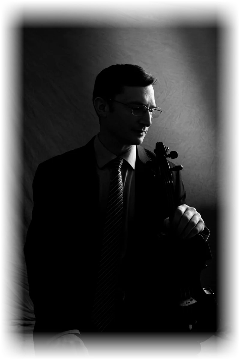 Jeremy Black seated with his violin